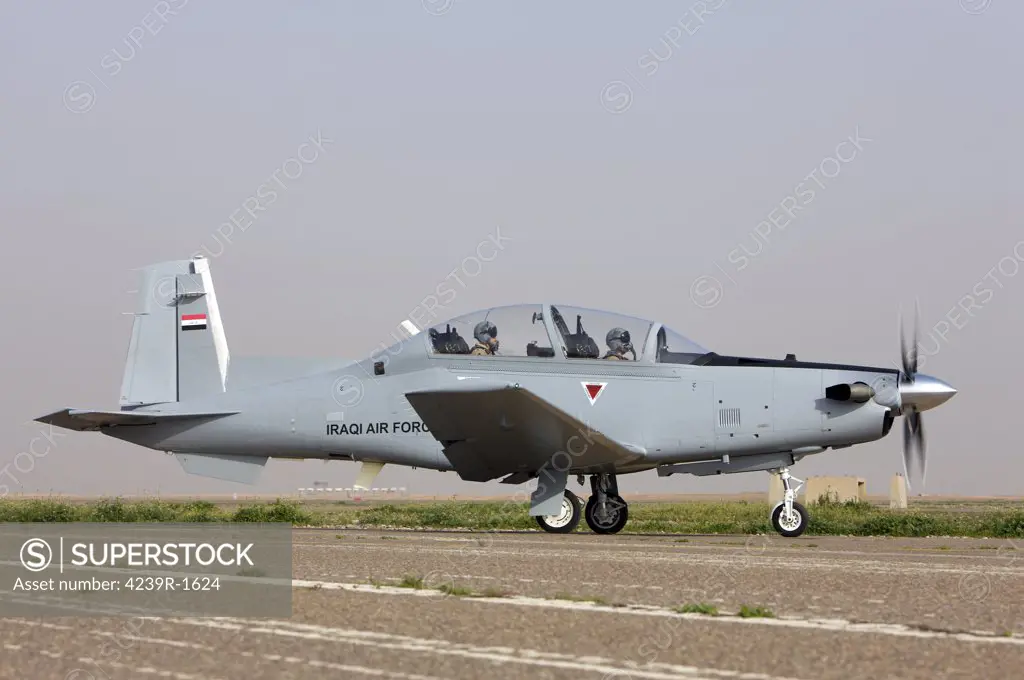 An Iraqi Air Force T-6 Texan trainer aircraft taxis out for a flight over Tikrit, Iraq