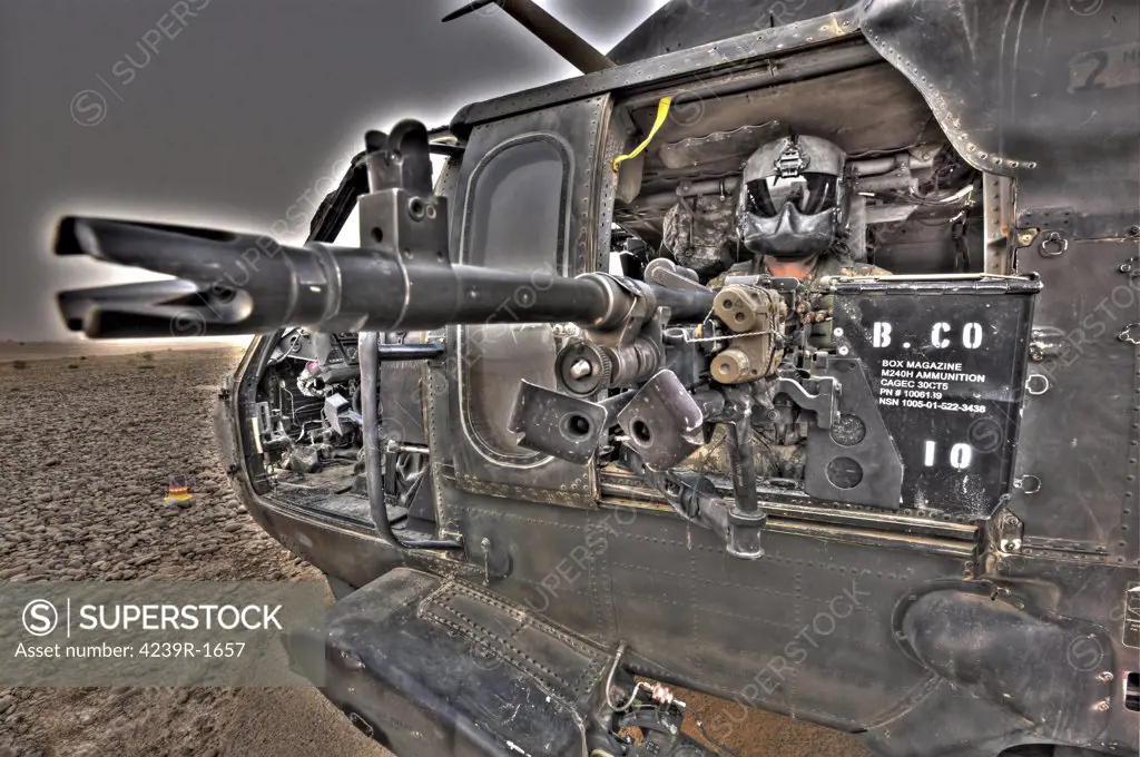 A high dynamic range image of a UH-60 Black Hawk door gunner manning a M240G medium machine gun