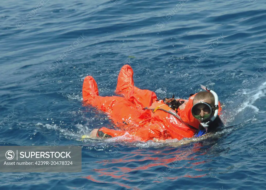 A Sailor rescued by a diver after escaping from the Italian Salvatore Pelosi Class Submarine Primo Longobardo not shown in the Submarine Escape and Immersion Equipment (SEIE) MK-10 suit during the North Atlantic Treaty Organization (NATO) Submarine Escape and Rescue (SERS) Exercise Sorbet Royal 2005. 