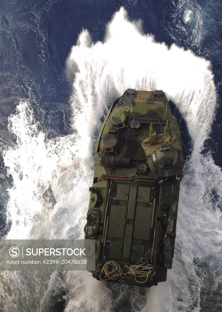March 23, 2010 - An amphibious assault vehicle exits the well deck of the forward-deployed amphibious assault ship USS Essex (LHD-2) while in the Philippine Sea.