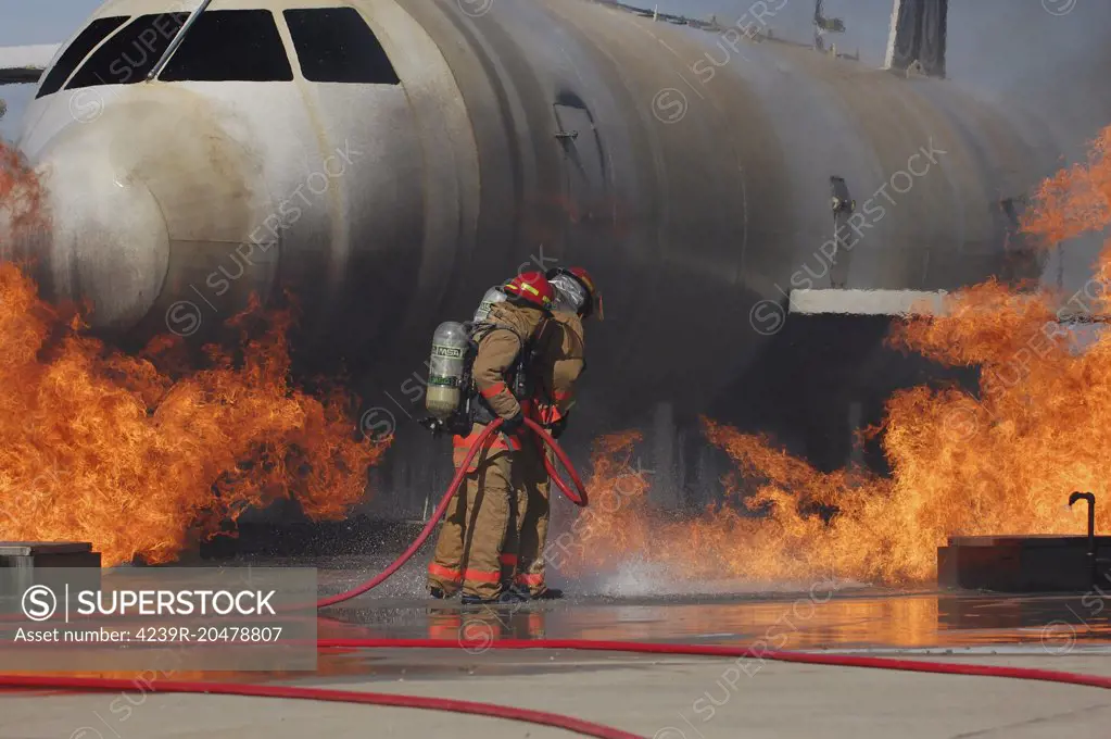 Goodfellow Air Force Base, Texas - Airmen extinguish a fire on a training module to demonstrate an aircraft incident.  