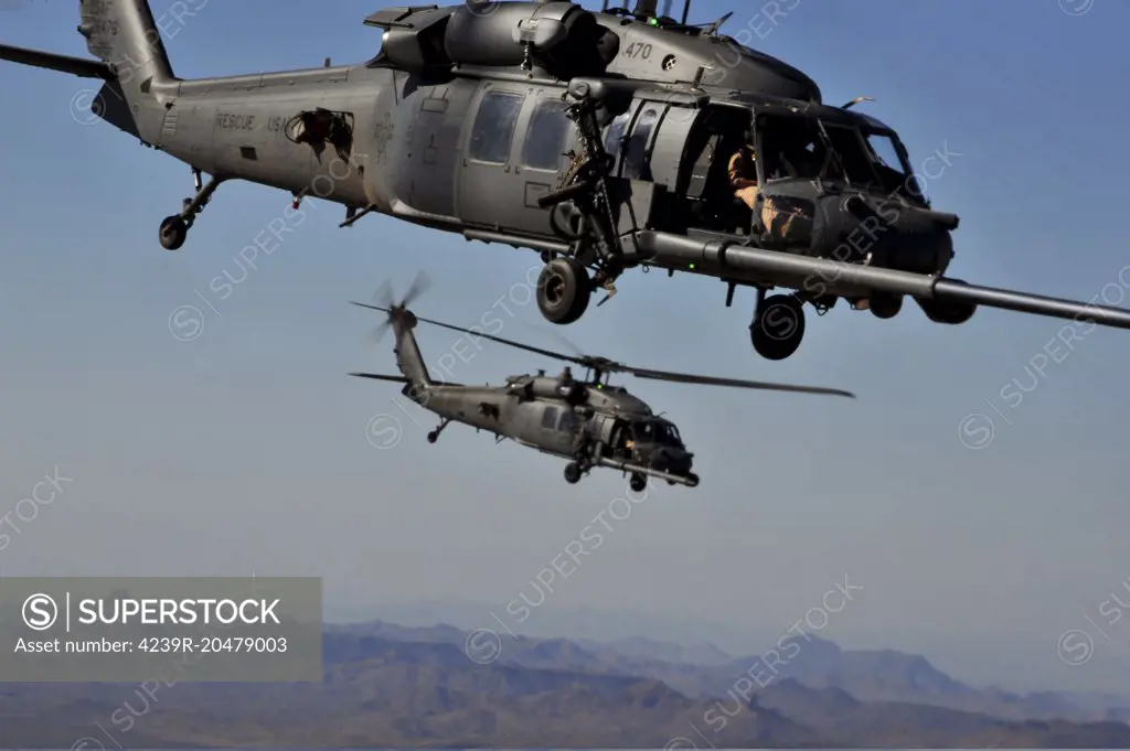 October 16, 2011 - Two U.S. Air Force HH-60 Pave Hawk helicopters maneuver behind an HC-130 King aircraft to perform a helicopter air refueling at Davis-Monthan Air Force Base in Arizona, during Angel Thunder 2011. 
