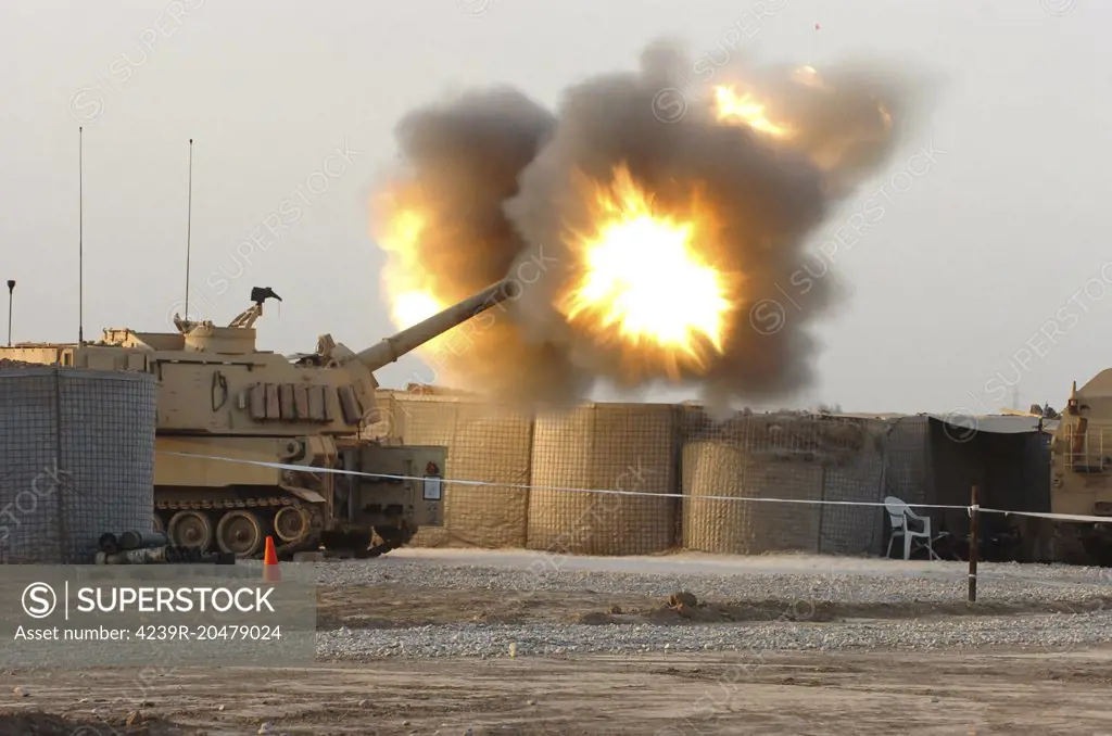 March 13, 2007 - Soldiers fire the howitzers on their M109A6 Paladins during the first-ever firing of the Modular Artillery Charge System in the combat zone by an entire Paladin battery on Camp Taji, Iraq. The MACS is a newly refined propellant that pushes projectiles out of the barrel of the howitzers. 