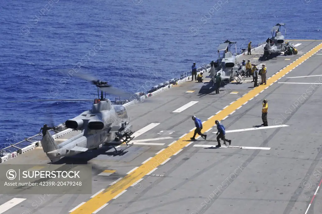 Philippine Sea, September 28, 2011 - AH-1Z Super Cobra helicopters land aboard the forward deployed amphibious assault ship USS Essex (LHD 2). 