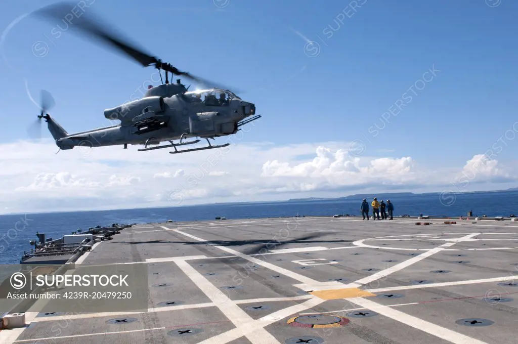 Philippine Sea, October 12, 2011 - An AH-1W Super Cobra helicopter lands aboard the forward-deployed amphibious transport dock ship USS Denver (LPD 9). 