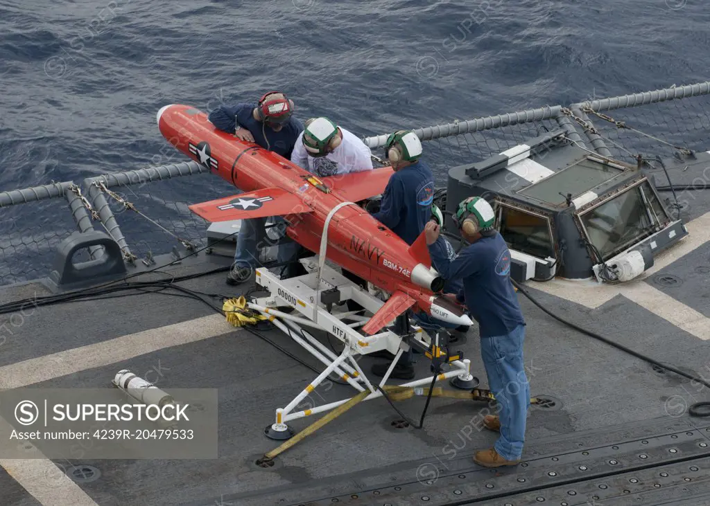 Caribbean Sea, September 21, 2012 - A team from NAVAIR Norfolk Detachment prepare a BQM-74E drone for launch from the flight deck of the Oliver Hazard Perry-class guided-missile frigate USS Underwood. 