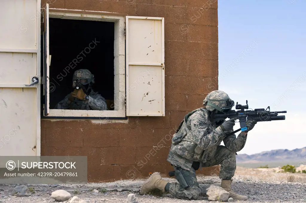 April 30, 2013 - Security forces Airmen guard a building during an urban operations training course at Nellis Air Force Base, Nevada. During the course, security forces Airmen were evaluated on how they enter buildings, handle detainees and react to attacks. 