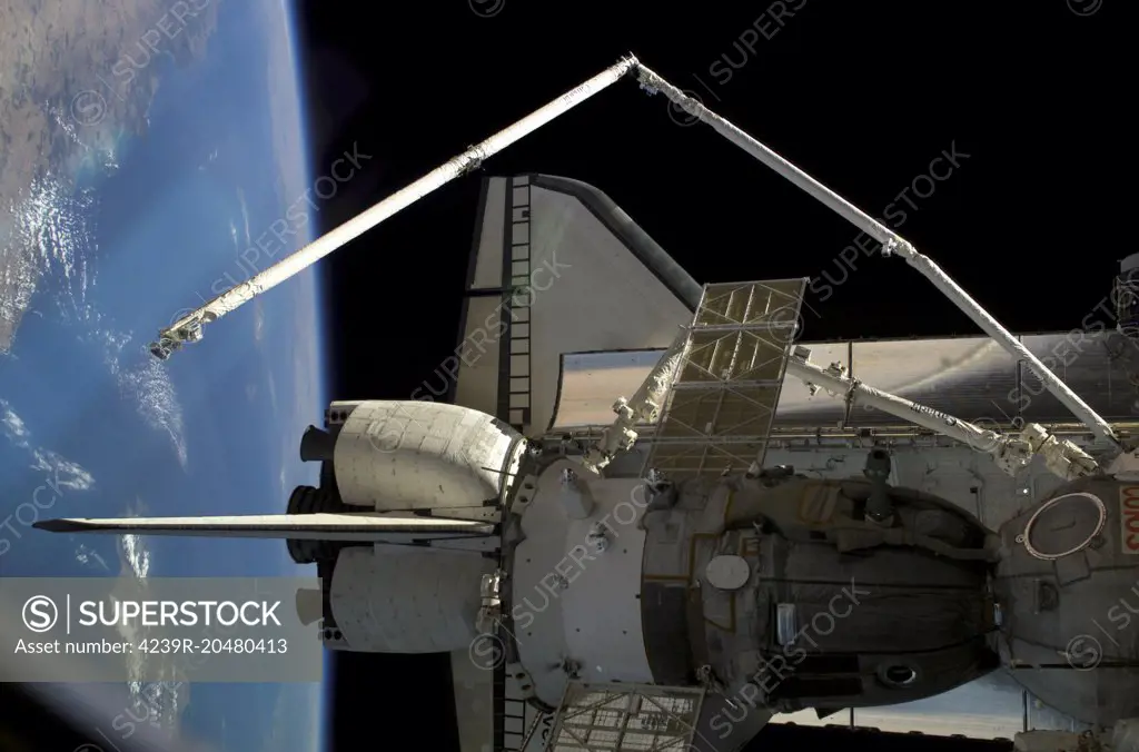 August 5, 2005 - Docked to the International Space Station, a Soyuz vehicle (foreground) and the Space Shuttle Discovery were photographed by a crewmember onboard the orbital outpost. Both the Shuttles Canadian-built remote manipulator system (RMS) robotic arm and the Stations Canadarm2 are visible. The blackness of space and Earths horizon formed the backdrop for the image.