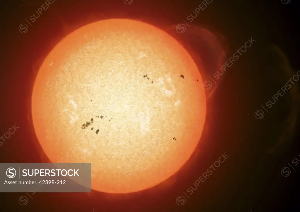 Illustration of the sun with visible dark sunspots on the surface, prominences and some solar wind blowing off at the right