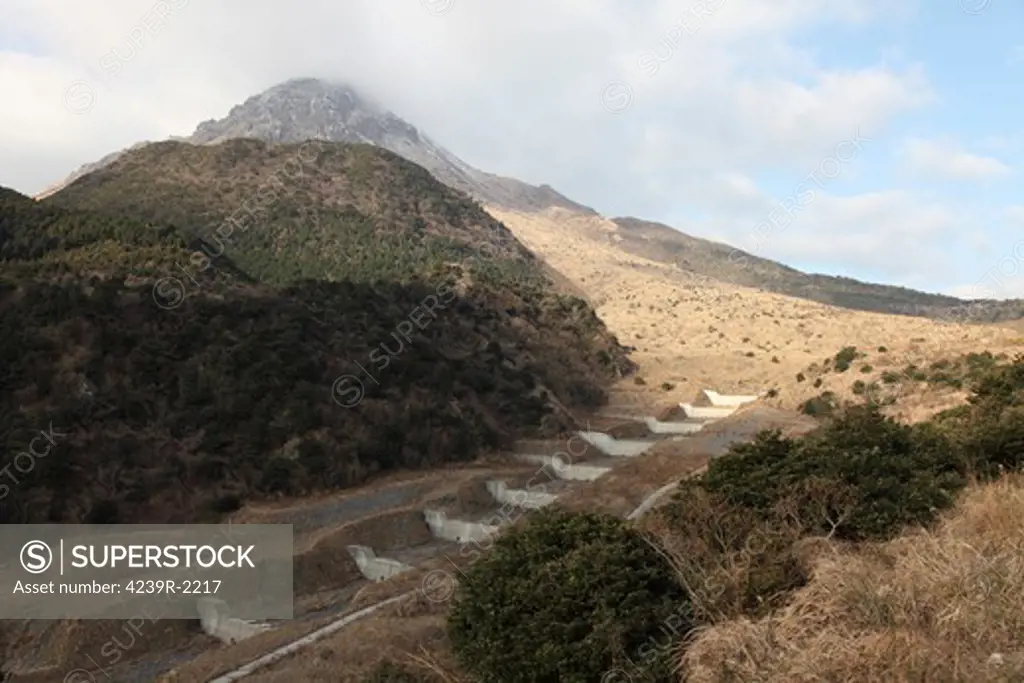 January 6, 2010 - Mount Unzen volcano, Japan. Last active in 1990-1995. Stepped check dams, for reduction of lahar (mudflow) hazard, in Oshigadani gorge in foreground.