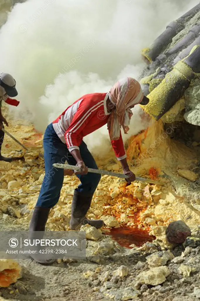 August 12, 2011 - Miner breaking up sulphur deposits at Kawah Ijen volcano, Java, Indonesia.