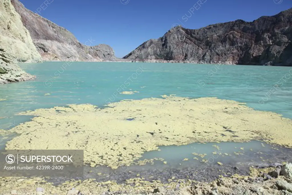 August 13, 2011 - Sulfurous raft floating on surface of turquoise acidic crater lake, Kawah Ijen volcano, Java, Indonesia.