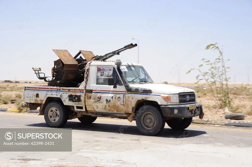 A Free Libyan Army pickup truck converted into a technical with a ZPU-2 anti-aircraft gun, Ajdabiya, Libya.  A war betwean Gaddafi army and Libya's Transitional National Council army with air support from NATO started on March 17, 2011.