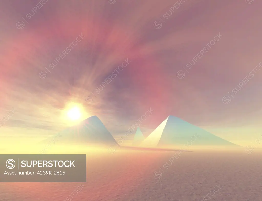 The sun rises on Egyptian pyramids on a desert morning.