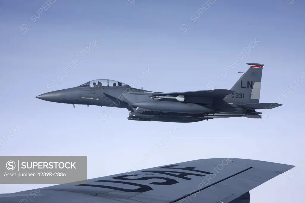 U.S. Air Force McDonnell Douglas F-15E Strike Eagle over the wing of a Boeing KC-135 Stratotanker.