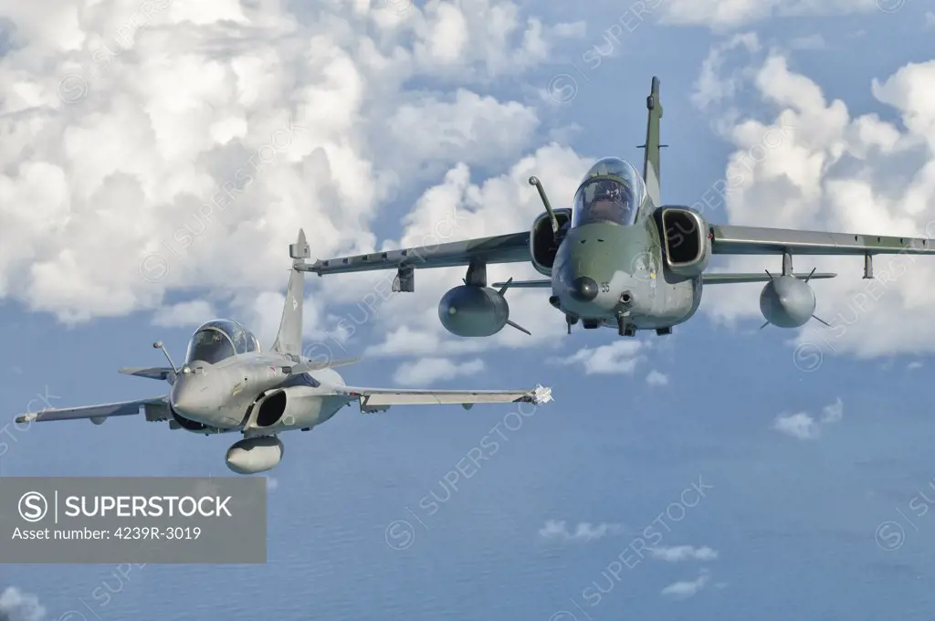 A Dassault Rafale of the French Air Force flys alongside an Embraer A-1B of the Brazilian Air Force during Cruzeiro Do Sul (CRUZEX) in Brazil. CRUZEX V is a multinational exercise encompassing real means from the Air Forces of Argentina, Brazil, Chile, France, Uruguay, United States, Venezuela and simulated means from Land and Maritime Components that takes place October 28th to November 19th, 2010, on the Northeast coast of Brazil.