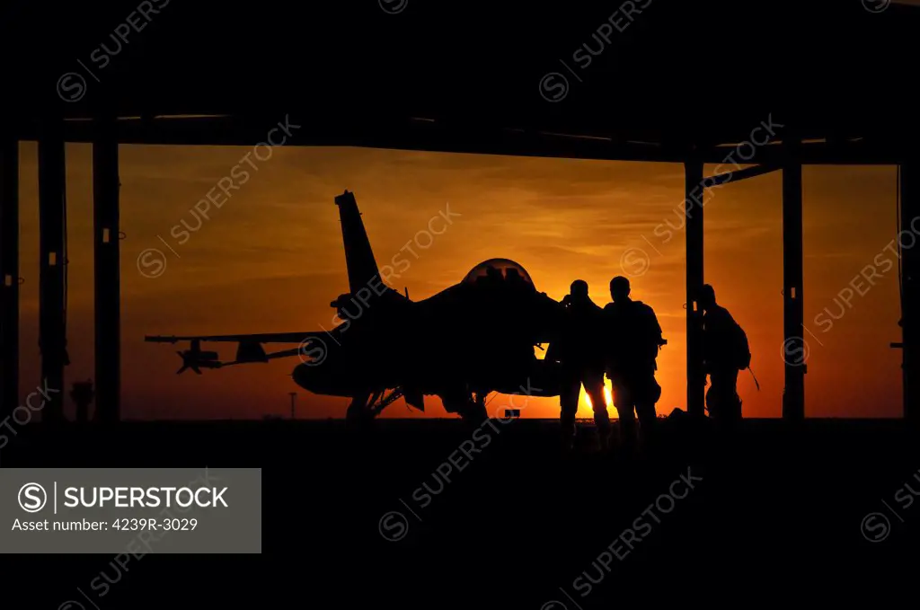 Silhouette of a Chilean Air Force F-16C Block 50 aircraft seen during sunset in the hangar at Natal Air Force Base, Brazil, during Cruzeiro Do Sul (CRUZEX). CRUZEX V is a multinational exercise encompassing real means from the Air Forces of Argentina, Brazil, Chile, France, Uruguay, United States, Venezuela and simulated means from Land and Maritime Components that takes place October 28th to November 19th, 2010, on the Northeast coast of Brazil.