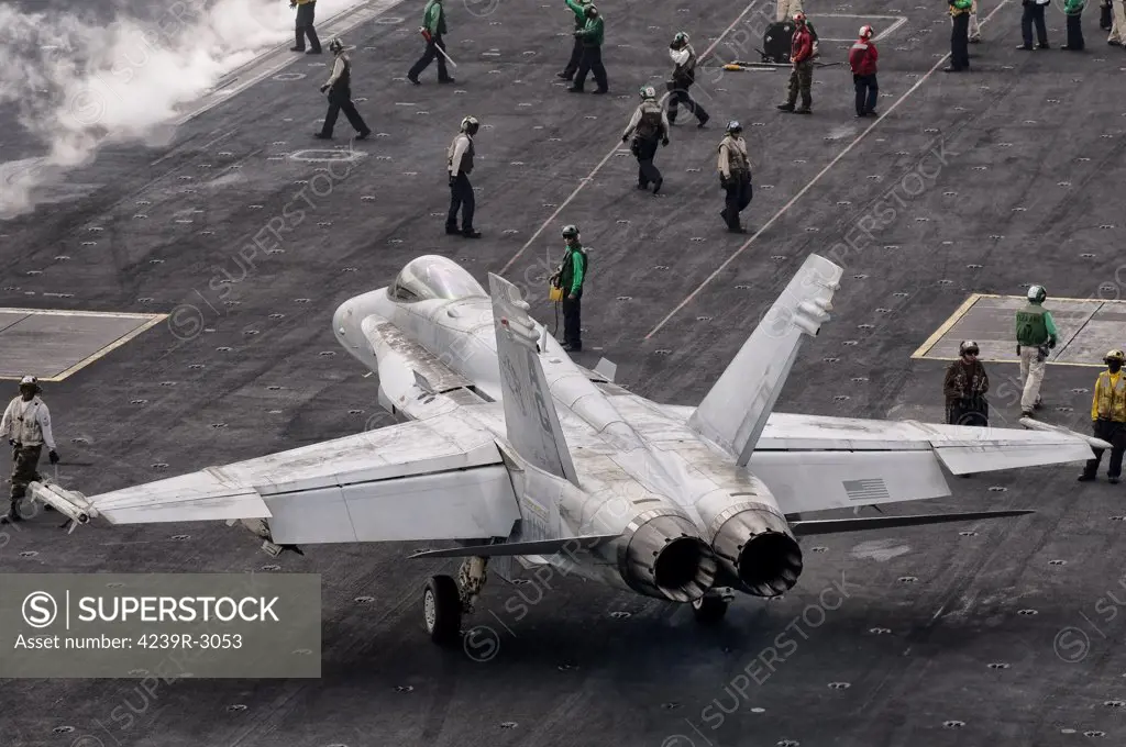 A US Navy F/A-18C Hornet on the flight deck of aircraft carrier USS Eisenhower. Eisenhower is operating in the 5th fleet area of responsibility off the coast of Pakistan.