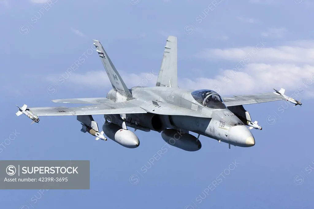 April 8, 2011 - A CF-188A Hornet of the Royal Canadian Air Force carrying laser guided bombs and AIM-9 Sidewinder missiles while bound for Libya during Operation Unified Protector.