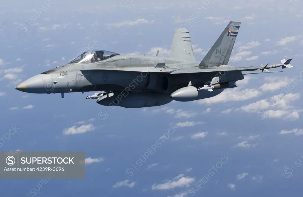 April 8, 2011 - A CF-188A Hornet of the Royal Canadian Air Force carrying laser guided bombs and AIM-9 Sidewinder missiles while bound for Libya during Operation Unified Protector.