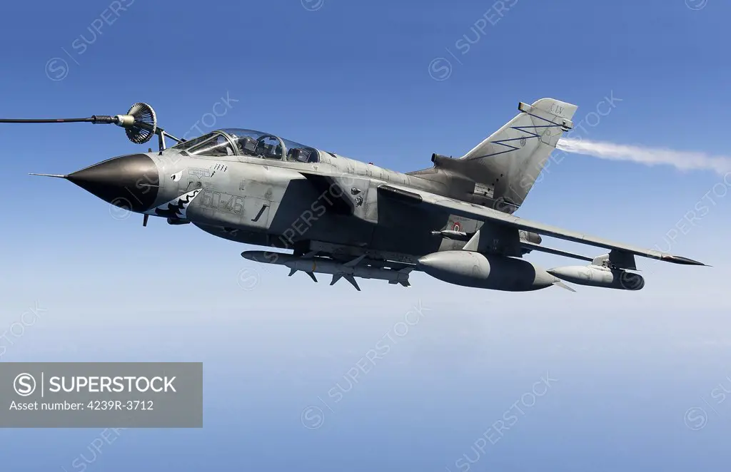 April 8, 2011 - An Italian Air Force Panavia Tornado IDS armed with AGM-88 HARM missiles shortly before entering Libyan airspace for a suppression of enemy air defenses mission in support of Operation Unified Protector over the Mediterranean Sea close to Libya. The aircraft is venting fuel from its tail.