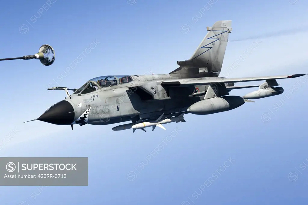 April 8, 2011 - An Italian Air Force Panavia Tornado IDS armed with AGM-88 HARM missiles shortly before entering Libyan airspace for a suppression of enemy air defenses mission in support of Operation Unified Protector over the Mediterranean Sea close to Libya. The aircraft is venting fuel from its tail.