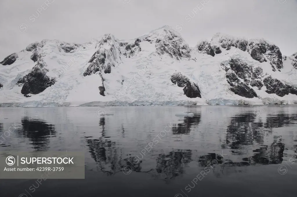 Antarctic mountains reflected in the sea, Antarctica.