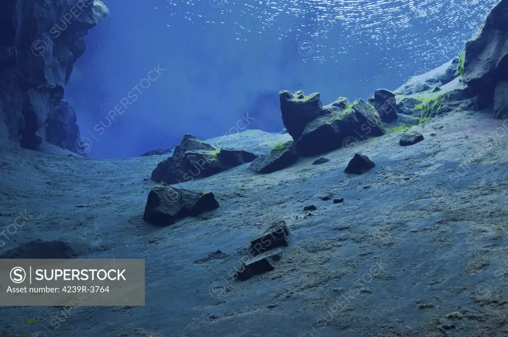 Blue underwater lunar landscape in the clear water of the lagoon at Silfra Crack, Iceland.