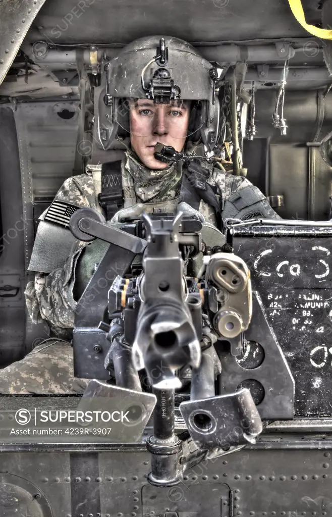 A high dynamic range image of a UH-60 Black Hawk door gunner manning a M240G medium machine gun.