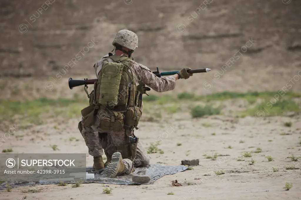 U.S. Marine prepares a high-explosive fragmentation round for the RPG-7 rocket-propelled grenade launcher in a wadi near Kunduz, Afghanistan.
