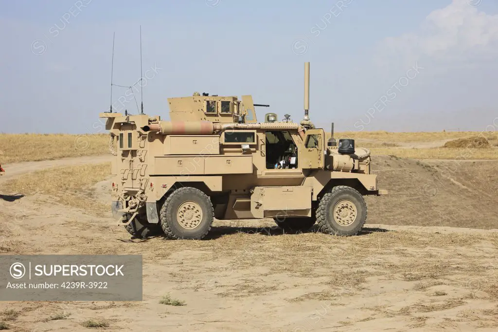 A U.S. Army Cougar MRAP vehicle parked overlooking the top of a wadi during a weapons familiarization shoot, Kunduz, Afghanistan