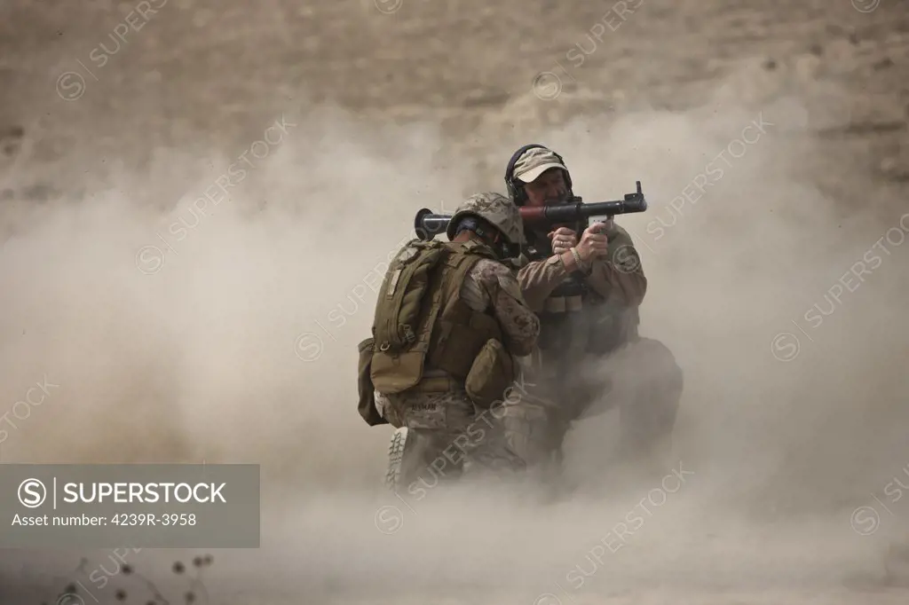U.S. Marine fires an HE fragmentation round from the RPG-7 rocket-propelled grenade launcher in a wadi near Kunduz, Afghanistan.