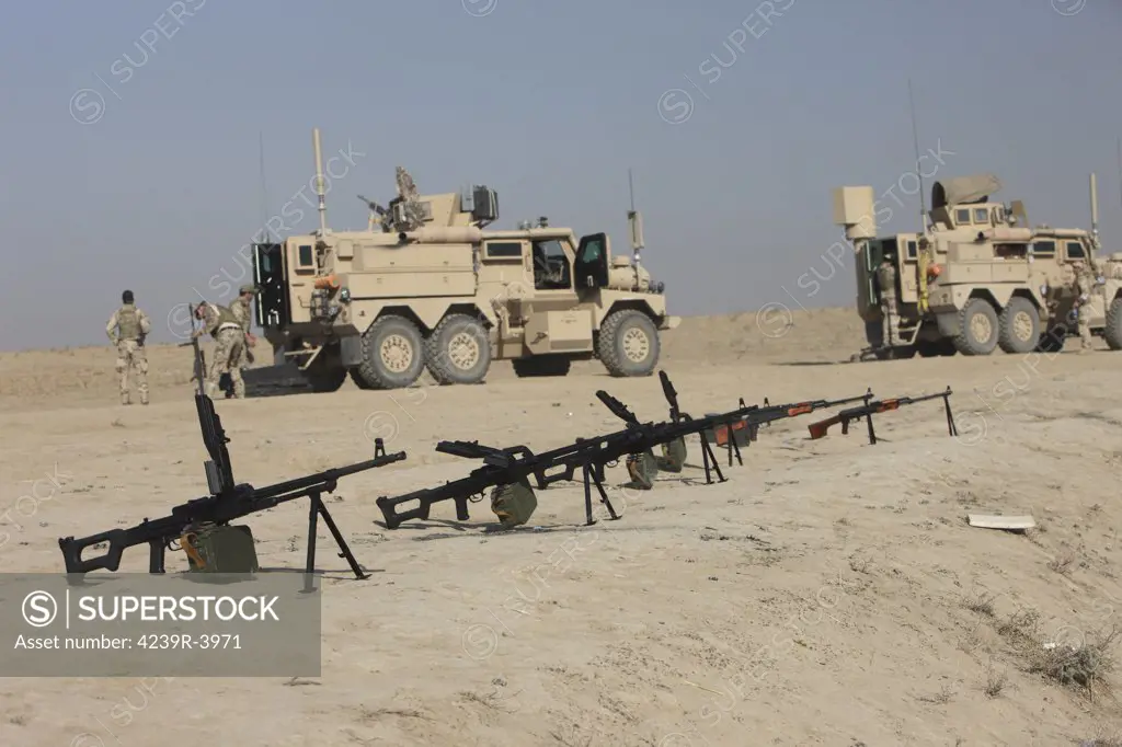 PK 7.62 mm general-purpose machine guns and RPK Kalashnikov rifles sit ready on a firing range in Kunduz, Afghanistan.