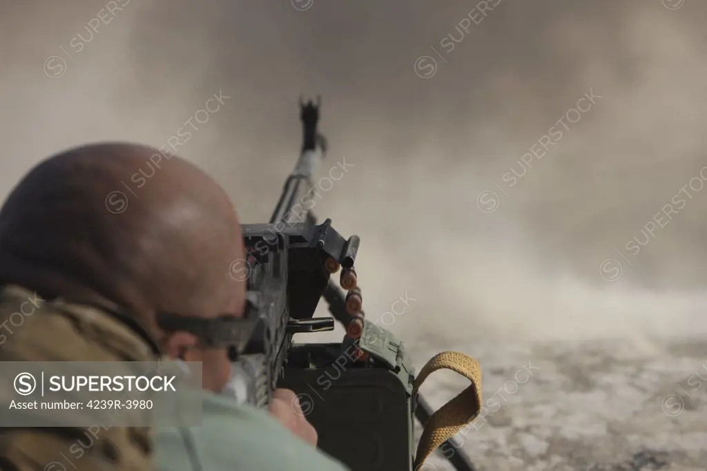 U.S. Contractor firing the automatic PKM 7.62 machine gun on the firing range in Kunduz, Afghanistan.