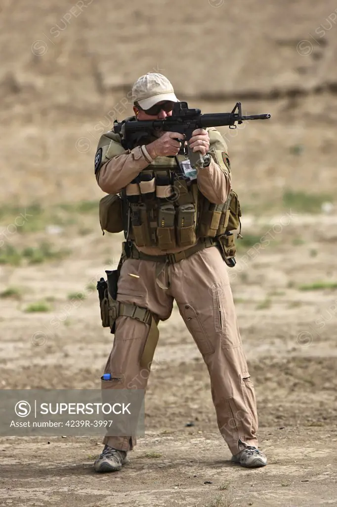 Kunduz, Afghanistan - U.S. Contractor firing a 5.56mm M4 Carbine.