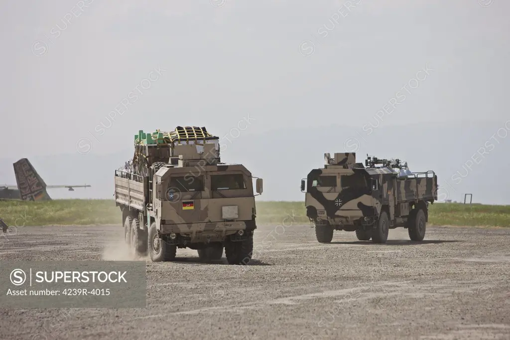 Kunduz, Afghanistan - A couple of fully laidened German Army MAN 7t mil gl 6x6 Pritsche depart Kunduz Airport for the German Army Provincial Reconstruction Team camp 1 mile up the road