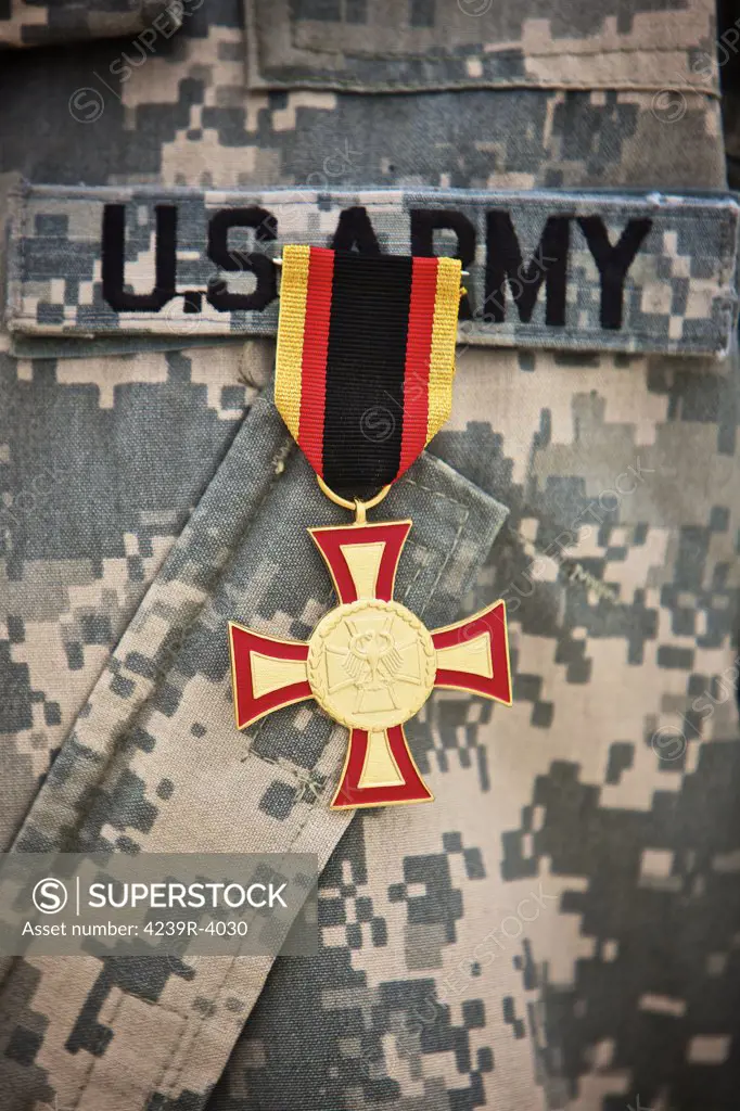Close-up view of a German Gold Cross worn by a U.S. Army soldier. The German Gold Cross is one of the highest levels of the Badge of Honour, a military decoration given by the Bundeswehr of the Federal Republic of Germany.