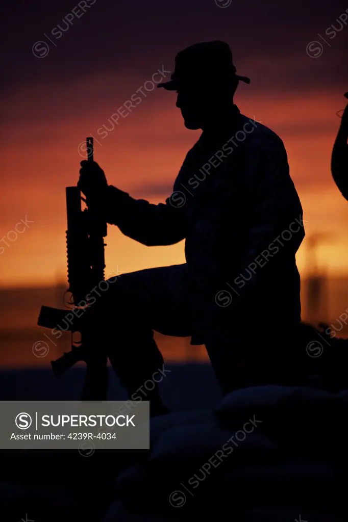 Silhouette of a U.S Marine on a bunker at sunset in Northern Afghanistan.