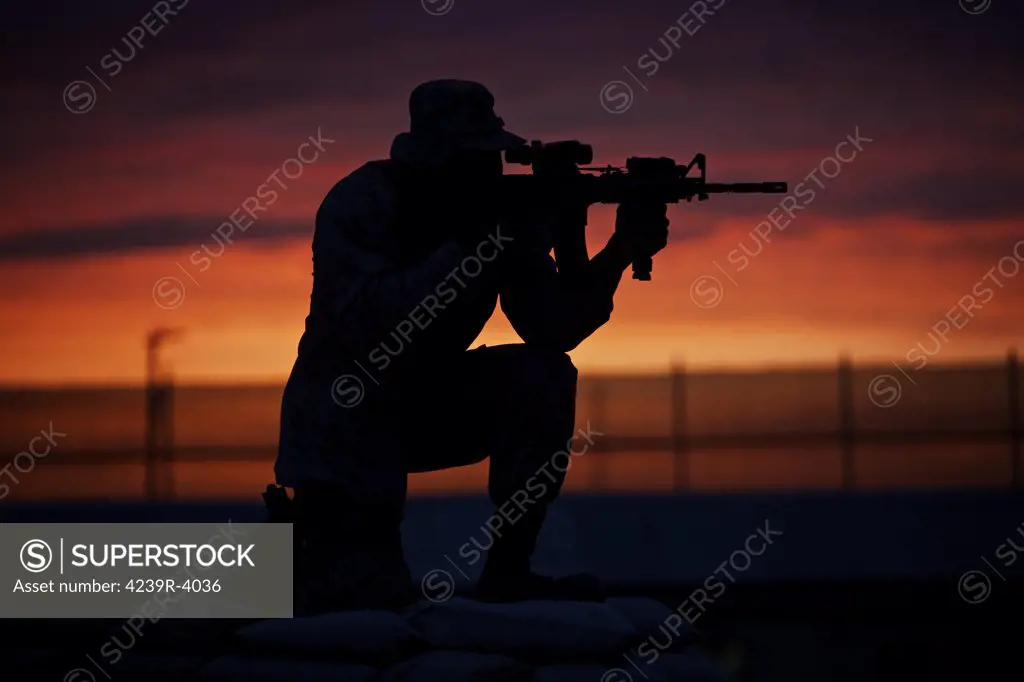 Silhouette of a U.S Marine on a bunker at sunset in Northern Afghanistan.