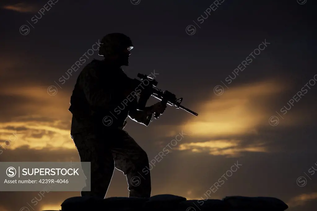 Partially silhouetted U.S. Marine on a bunker in Northern Afghanistan.