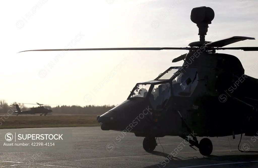 A German Tiger Eurocopter at Stendal Airfield, Germany, in preparation for Afghanistan deployment. A U.S. Army AH-64D Apache is in the background.