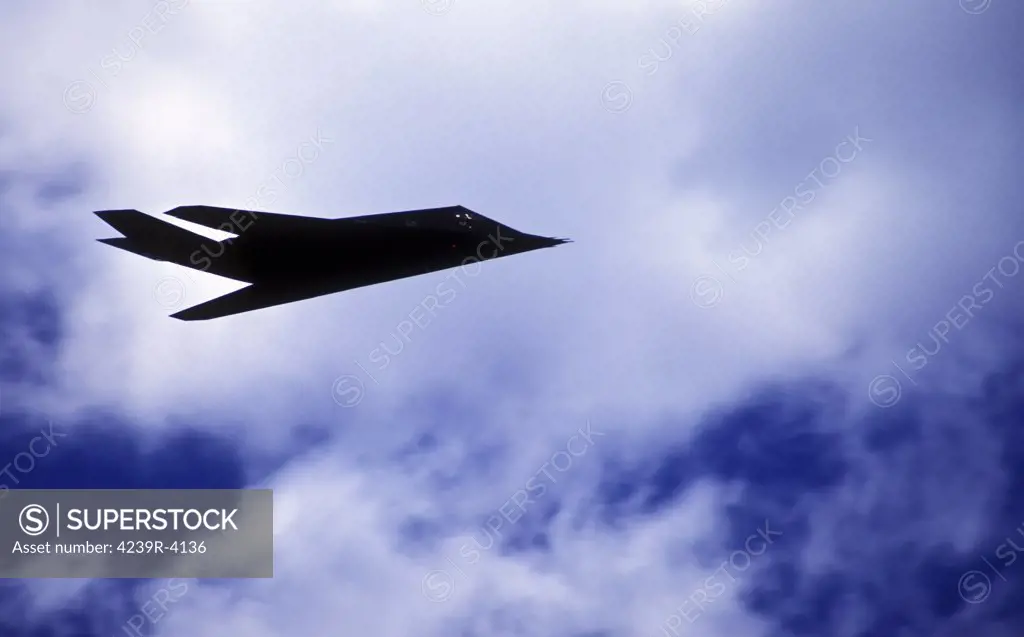 The F-117A Nighthawk stealth fighter climbs into the clouds above the Hickham Air Force Base during an air demonstration in Hawaii as part of the Rim of the Pacific (RIMPAC) Joint and International exercise in 1996.¾