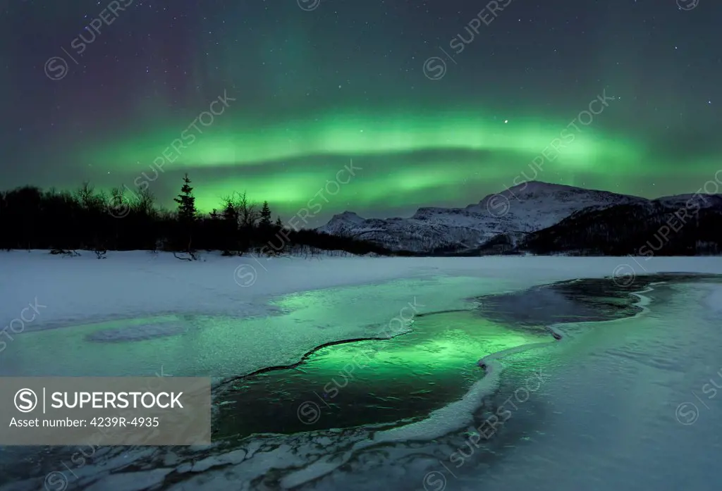 Reflected aurora over a frozen Laksa Lake, Nordland, Norway.