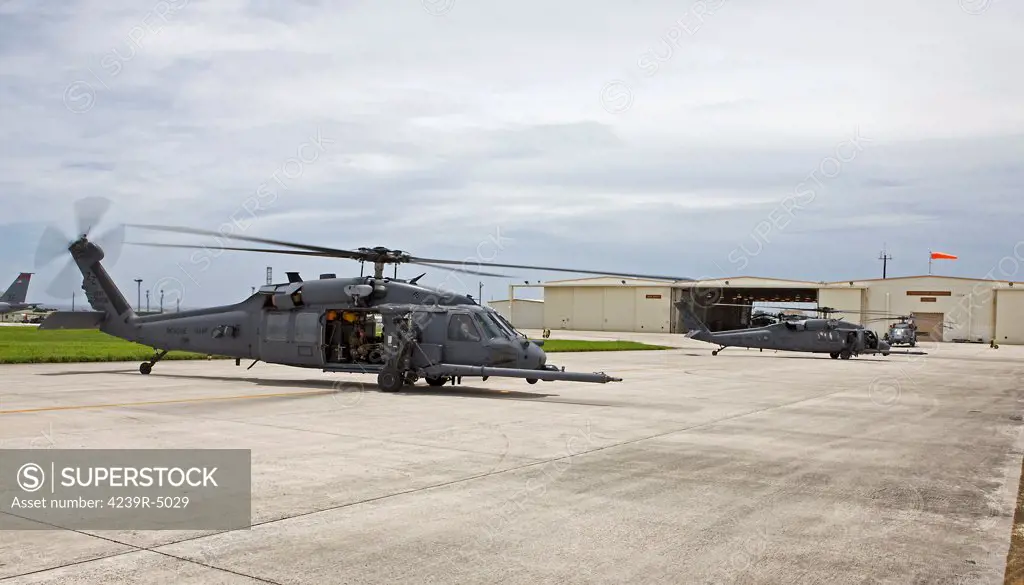 Two HH-60G Pave Hawk helicopters from the 33rd Rescue Squadron prepare to take off on a training mission at Kadena Air Base, Okinawa, Japan.