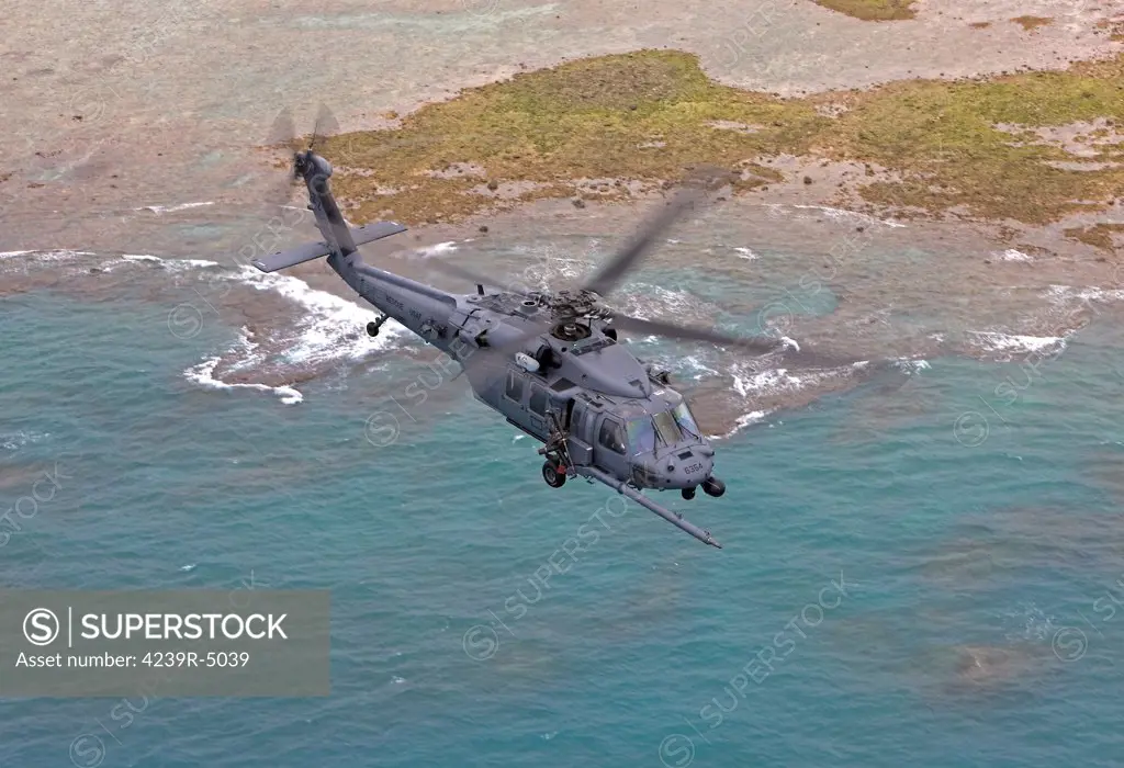 An HH-60G from the 33rd Rescue Squadron flies along the Okinawa coastline during a training mission out of Kadena Air Base, Okinawa, Japan.