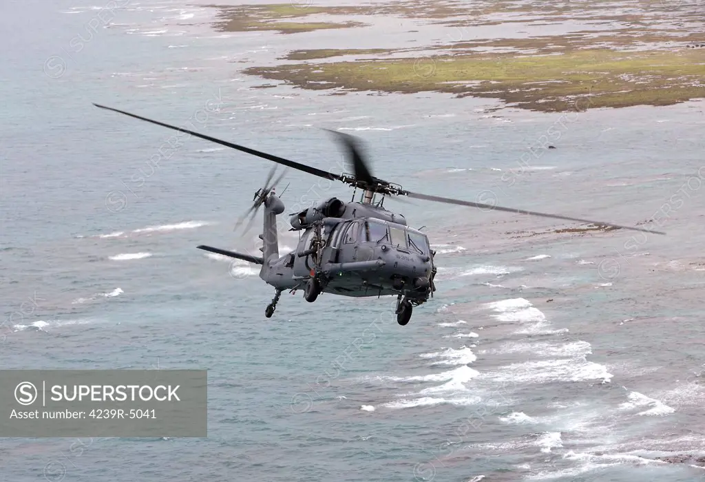 An HH-60G Pave Hawk from the 33rd Rescue Squadron flies along the Okinawa coastline during a training mission out of Kadena Air Base, Okinawa, Japan.