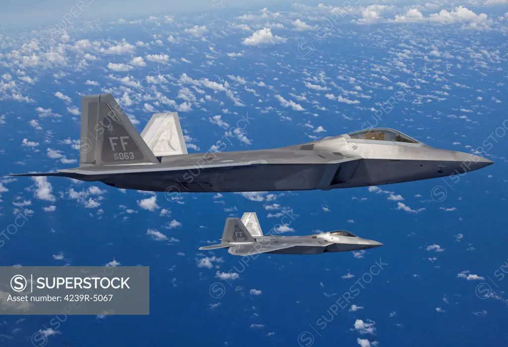 Two F-22 Raptors from the 1st Fighter Wing at Langley Air Force Base, Virginia, fly in formaton during a training mission out of Kadena Air Base, Okinawa, Japan.