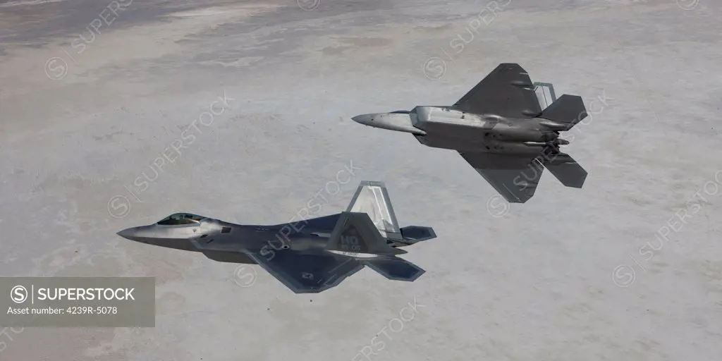 Two F-22 Raptors from the 49th Fighter Wing manuever while on a training mission out of Holloman Air Force Base, New Mexico.