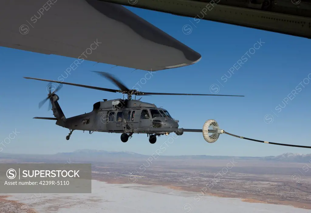 An HH-60G Pave Hawk from the 512th RQS conducts aerial refueling from an HC-130 during a training mission out of Kirtland Air Force Base, New Mexico.