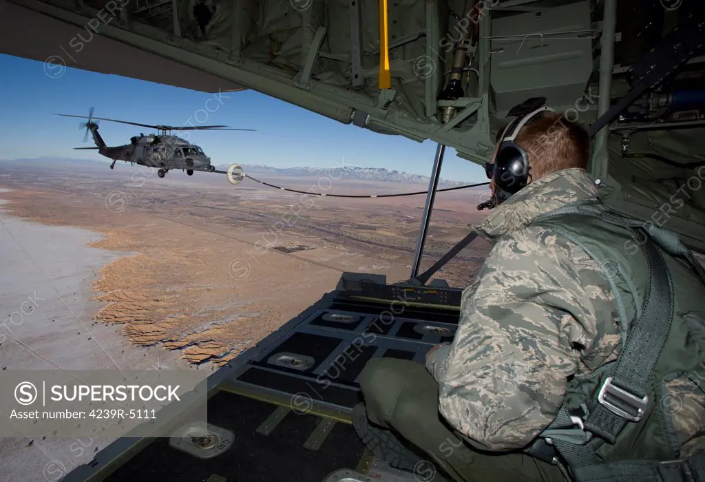 A loadmaster on an HC-130 watches as an HH-60G Pave Hawk from the 512th RQS conducts aerial refueling during a training mission out of Kirtland Air Force Base, New Mexico.